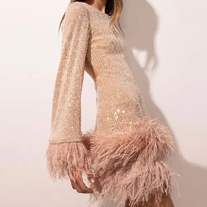 Glamorous dress with sequins and feather hem